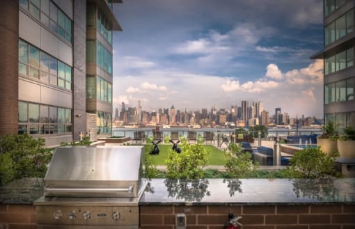Rooftop terrace with grill and city skyline views at RiverParc Apartments, Weehawken
