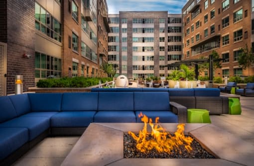 Outdoor fire pit with seating and building views at RiverParc Apartments, New Jersey, 07086
