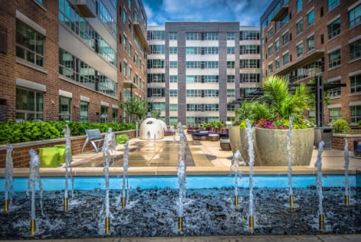 Courtyard water feature with fountain jets and planters at RiverParc Apartments, Weehawken, New Jersey