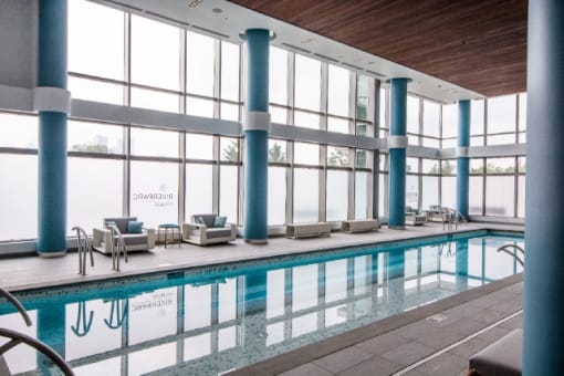 Indoor pool with floor to ceiling windows at RiverParc Apartments, Weehawken, NJ
