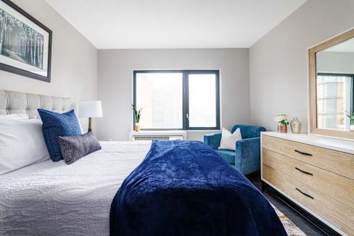 A bedroom with a large bed and a blue blanket.