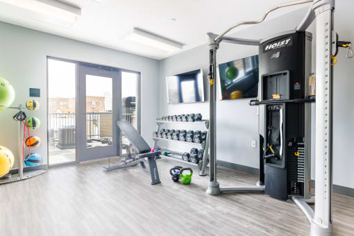 a home gym with a treadmill and weights