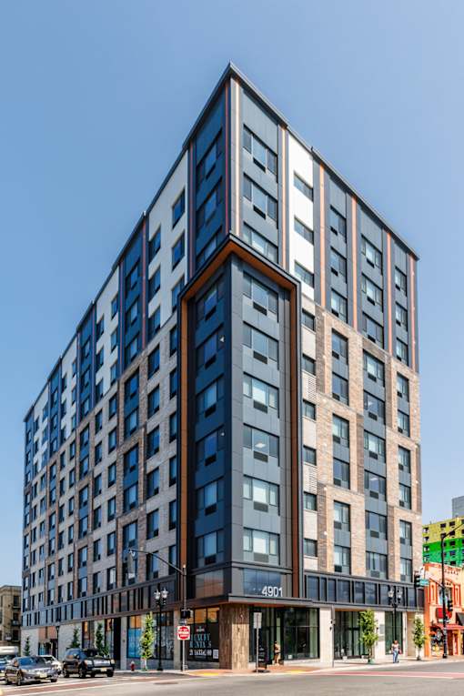 A tall building with a blue sky in the background.