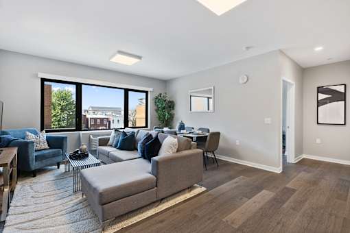 A living room with a grey couch and a coffee table.