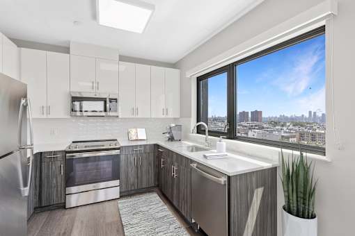 A modern kitchen with a view of the city.