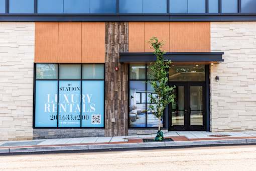 A building with a sign that says "LUXURY RENTALS" on it.