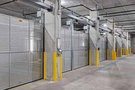 A long row of storage units with yellow posts.