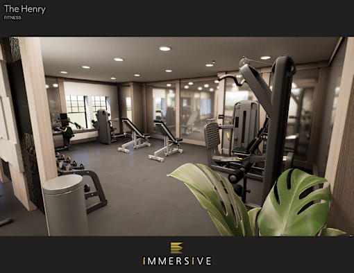 A gym with a variety of equipment and a green plant in the foreground.