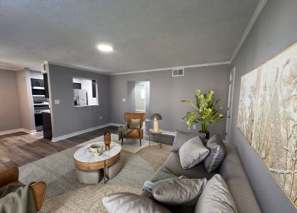 Bright renovated living room with luxury vinyl flooring and soft neutral paint tones in a 2-bedroom apartment at Lynnhaven Landing in Virginia Beach
