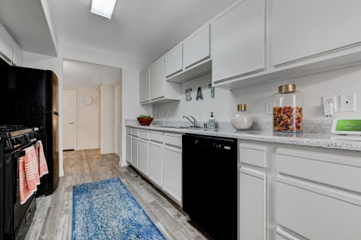 a kitchen with white cabinets at The Dresden, Las Vegas, NV, 89122