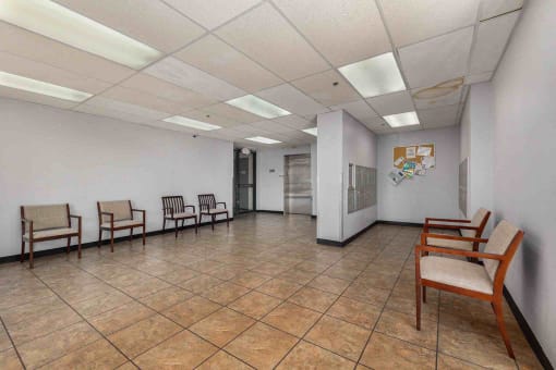 a waiting room filled with chairs and a door