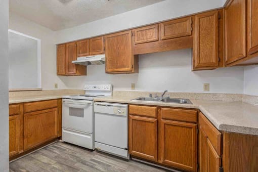 a kitchen with white appliances and wooden cabinets