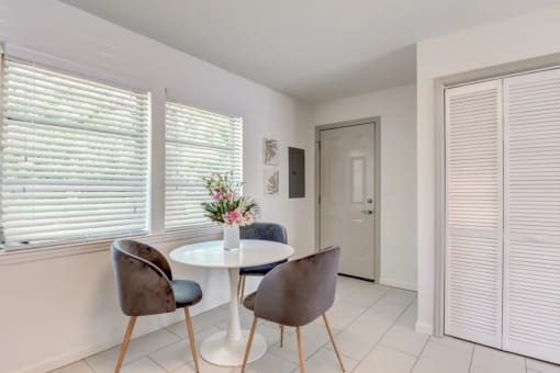 a dining room with a table and chairs