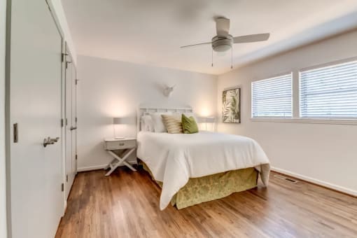 a bedroom with a bed and a ceiling fan