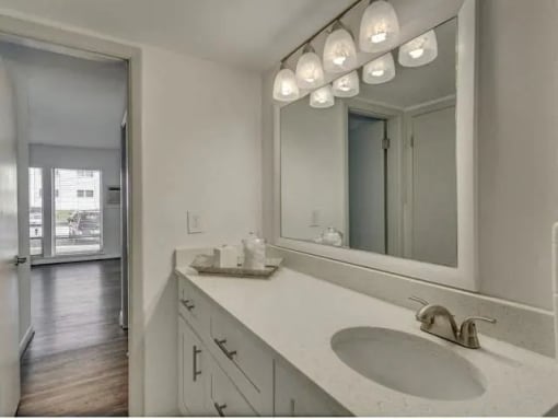 an empty room with a mirrored wall and a window