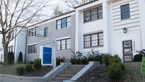 A white building with a blue door and windows.