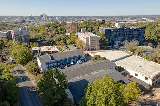 A large building complex with a parking lot in front of it.