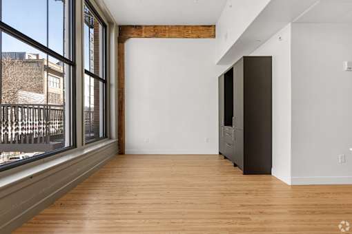 A room with a wooden floor and a large window.