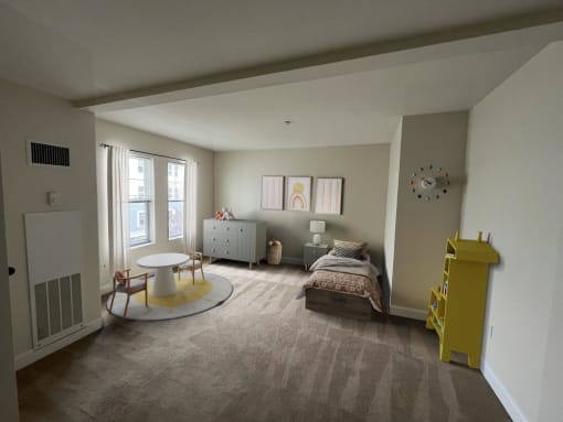 a bedroom with a bed and a table in a room