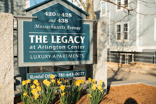 A sign for The Legacy at Arlington Center Luxury Apartments with a rental office number.