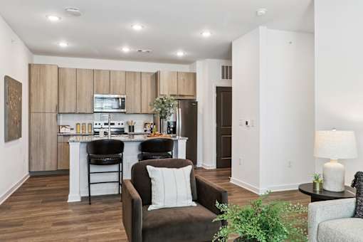 A modern kitchen with a dining area and a living room.at The Liliana Apartment Homes, Pooler, GA 31322