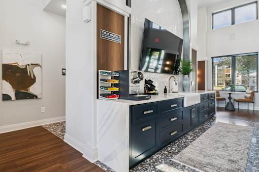 A modern kitchen with dark wood cabinets and a white countertop.at The Liliana Apartment Homes, Pooler Georgia