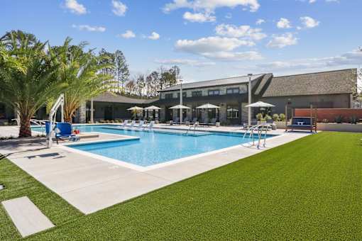 Pool With Lounge Chairs at The Liliana Apartment Homes, Pooler