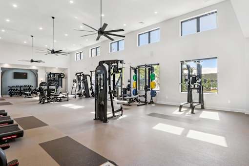 A spacious gym with a variety of equipment at The Liliana Apartment Homes, Pooler Georgia