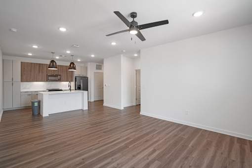 A spacious room with a ceiling fan and wooden flooring. at The Pullman Luxury Apartments, Atlanta, GA, 30349