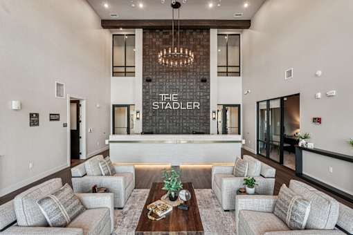 A modern living room with a chandelier at The Stadler Luxury Apartments, Bradenton, FL