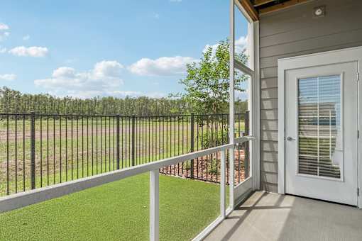 Covered balcony with artificial turf and pond views at Velara Luxury Apartments, Ponte Vedra Beach, 32081