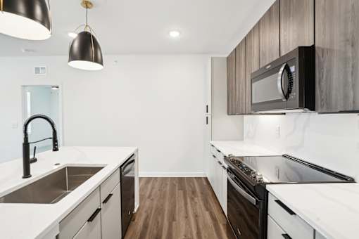 A modern kitchen with a black and white color scheme. at The Pullman Luxury Apartments, Atlanta, GA