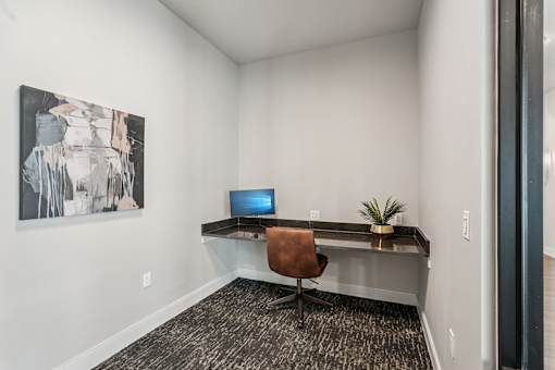 A room with a desk and a painting on the wall at The Stadler Luxury Apartments, Bradenton, FL 34210
