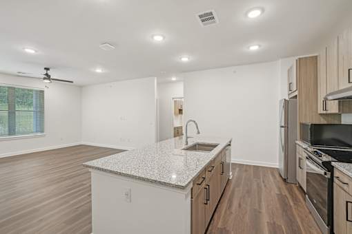 A kitchen with a countertop and a fan on the ceiling. at The Pullman Luxury Apartments, Atlanta, Georgia