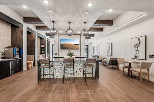 A modern living room with a wooden floor and a large painting on the wall at The Stadler Luxury Apartments, Bradenton, 34210