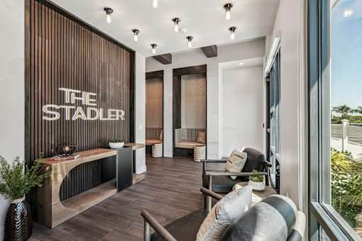 A modern living room with a wooden wall at The Stadler Luxury Apartments, Florida 34210