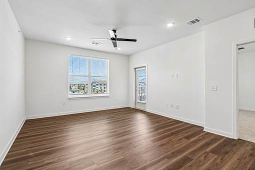 Empty bedroom with wood flooring and balcony access at Velara Luxury Apartments, Florida, 32081