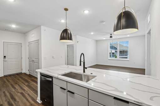 Kitchen island with marble countertops and pendant lighting at Velara Luxury Apartments, Ponte Vedra Beach, 32081