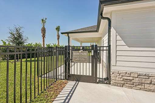 A black gate with a sign at The Stadler Luxury Apartments, Bradenton, FL