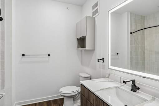 Modern bathroom with floating vanity and backlit mirror at Velara Luxury Apartments, Ponte Vedra Beach, FL