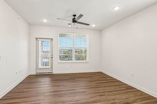 Spacious empty room with wood flooring and door at Velara Luxury Apartments, Ponte Vedra Beach, 32081