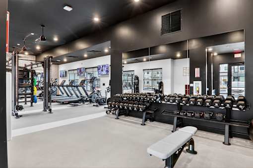 A gym with a variety of equipment including weights and a bench.at The Logan Luxury Apartments, Nampa, ID, 83651