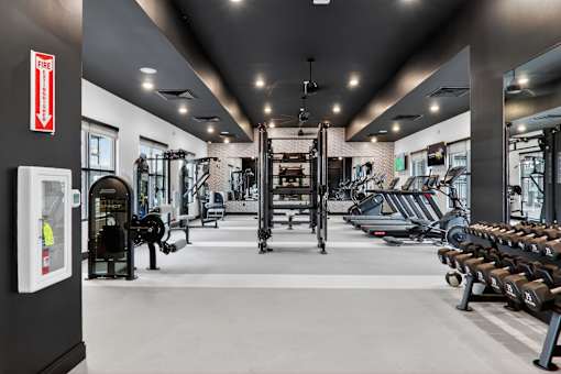A gym with a variety of equipment including treadmills, weights, and exercise machines.at The Logan Luxury Apartments, Nampa, ID, 83651