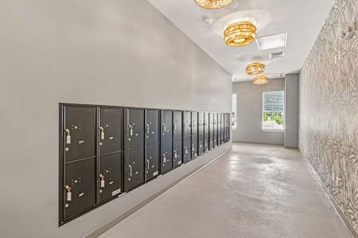 Mailroom with builtin lockers and decorative lighting at Velara Luxury Apartments, Ponte Vedra Beach, FL 32081