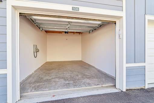 Private garage with concrete floor and overhead door at Velara Luxury Apartments, Ponte Vedra Beach, FL