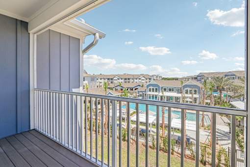 Covered balcony overlooking community pool and buildings at Velara Luxury Apartments, Ponte Vedra Beach, Florida