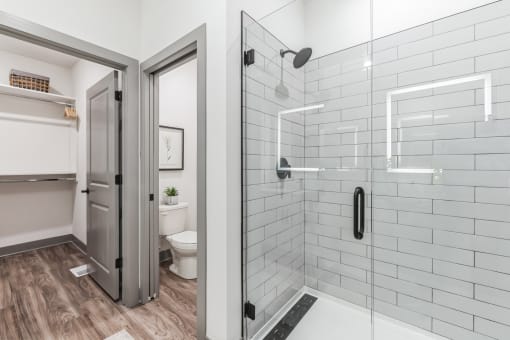 a white bathroom with a shower and a toilet at Meridian at CityPlace, Minnesota