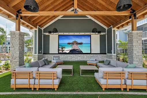 A wooden outdoor theater with a screen and seating.