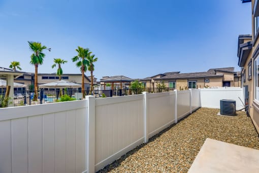 the preserve at ballantyne commons apartments balcony and yard with palm trees  at Grandstone at Sunrise, Arizona