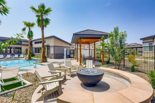 our apartments have a pool and lounge area with chairs and a fire pit  at Grandstone at Sunrise, Peoria, 85383